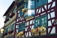 Timber-framed house with colourful windowboxes
